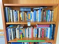 Two shelves filled with assorted travel, boating and reference books