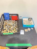 overview of tray with loose coins, coin folders, blue box of coins