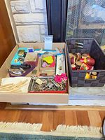Overview of box and basket showing majority of items including keys, clothespins, nesting dolls