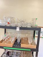 Shelves of assorted crystal glassware and decorative pieces