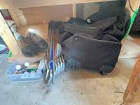 irons stacked, travel bag, shoes, accessory bin