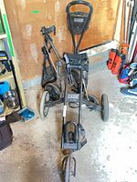 Two folded Cadie golf push carts showing overall design and brand label