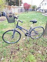 Full left-side view of Schwinn hybrid bike showing basket, frame style and flat tires