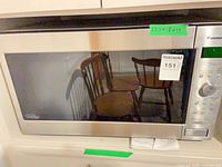 Front view showing stainless steel frame, black glass door, size label