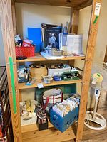Full shelving unit showing assorted sewing supplies, patterns, baskets and bins