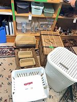 Overview showing wicker baskets, white hamper and laundry basket