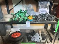 Shelved lot showing straps, foot packs, wheel, hardware