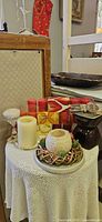 Overall lot showing fondue warmer, multiple candles, twig wreath, goblet candle