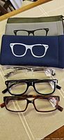 Three pairs reading glasses with two soft zipper pouches