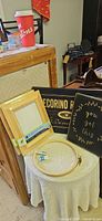 Lot showing two sealed wood frames, two hoops, two black plaques with gold lettering