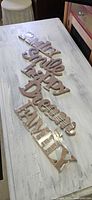 All five unfinished MDF word signs laid out to show text, size and condition