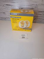 Front view of sealed Medela collection cups box with lot tag