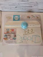 Front of unopened We R Memory Keepers 1-2-3 Punch Board package