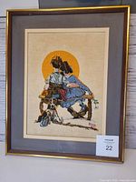 Front view of framed embroidered Norman Rockwell scene