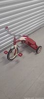 Full view of red and ivory Radio Flyer tricycle