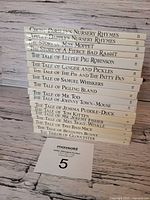 Stack of 18 Beatrix Potter hardcovers showing spines and titles