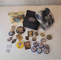 Full lot showing boxed card set, binoculars in case and plastic, and array of pins/buttons