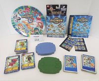 Group shot of plate, boxed starter set, rule book, Taco Bell cases, score counters, card stacks and mats