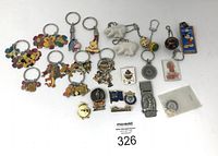 Full view of all keychains, pins and tie clip laid out