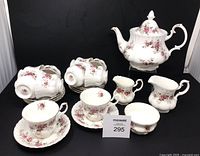 Full set showing teapot, creamers, sugar bowl, cups and saucers