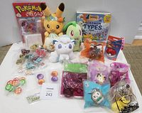 Entire lot layout: plush toys, books, dice packs, markers, McDonald’s toys, Mega Construx set, bracelet