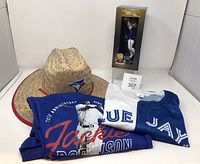 Group shot of straw hat, Gausman split jersey, Jackie Robinson T-shirt, and boxed Varsho bobblehead