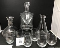 Group shot of three decanters and six stemless glasses