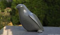 Front left view of soapstone falcon showing polished surface, shape and eye detail