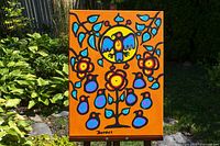 Full view of painting on easel in garden setting