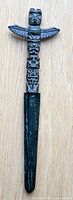 Full view of letter opener showing totem handle and blade