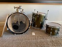 Entire 3-piece Ludwig drum kit laid out: bass drum with removed resonant head, two toms