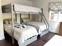 Full view of triple bunk bed, bedding in place