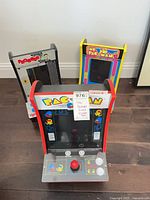 Three mini countertop arcade cabinets: Pac-Man front, Frogger left rear, Ms. Pac-Man right rear