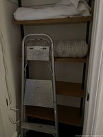 Ladder with two blankets on shelving