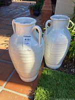 Front view of both matching amphora vases showing overall shape, glaze and handles