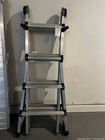 Front view of folded COSCO aluminum articulating ladder