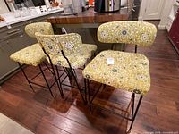 Front view of three stools at counter