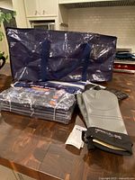 Packaged and opened Fygrip moving bags, oven mitts and grill gloves on counter