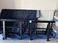 glass top and metal legs wrapped in moving blanket