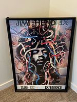 Full view of framed Hendrix poster leaning against wall