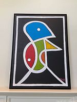 Front view of framed abstract bird painting