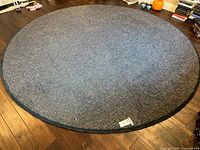 Full view of round area rug on wood floor
