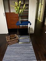 Full lot showing tray table, rug, basket, waste bin, vase with plant