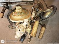 Pile of ornate cast metal wall sconces showing overall lot