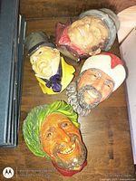All four Bossons character heads on wooden surface