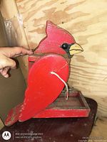 Left side view showing cardinal profile, paint, and base