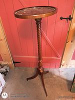 Full view of pedestal stand showing round top, spiral column and tripod base