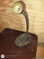 Full view of cast iron desk lamp on table