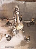 Full view of chandelier showing six arms, sockets, chain, canopy