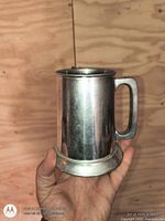 Side view of pewter tankard mug showing handle and foot